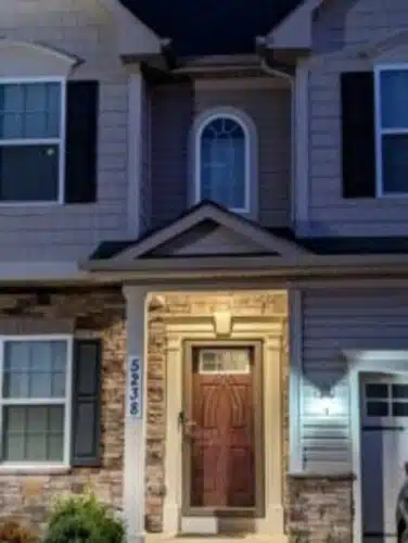 Front entrance of a two-story house at night.