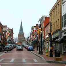 Historic downtown street with shops and cars.