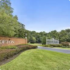 Residential neighborhood entrance with landscaped greenery.
