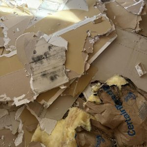 Damaged drywall and insulation removed during repairs.