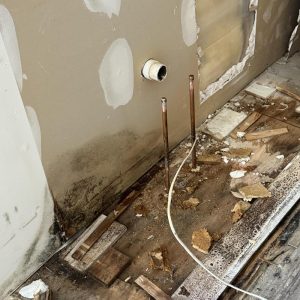 Wall and floor damage from water exposure during repairs.
