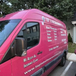 Top To Bottom Renovation service van parked outside residential property for home restoration services
