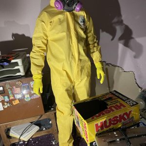 Technician in full protective suit and respirator during indoor contamination cleanup and restoration work