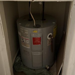 Water heater installed inside a utility closet.
