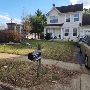 Two-story suburban home with front yard, driveway, and mailbox exterior view