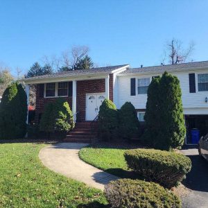 Single-story suburban home with brick and siding exterior and landscaped front yard