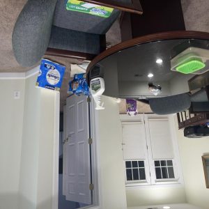 Dehumidifier and air scrubber equipment set up in a living area during water damage restoration and moisture control.