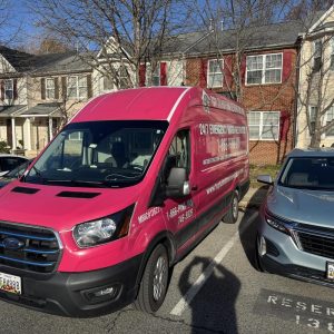 Emergency restoration service van parked in a residential area.