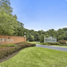 Residential neighborhood entrance with landscaped greenery.